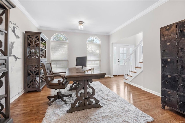 home office featuring wood finished floors, ornamental molding, and baseboards