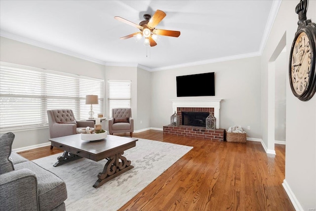 living room featuring a healthy amount of sunlight, ceiling fan, and baseboards