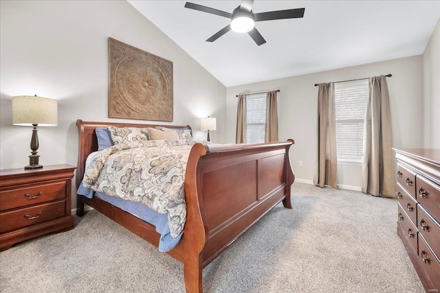 bedroom featuring baseboards, ceiling fan, light carpet, and lofted ceiling