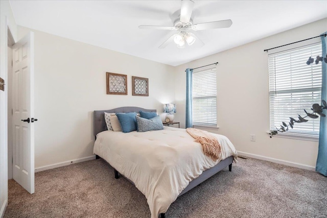 carpeted bedroom featuring baseboards and a ceiling fan