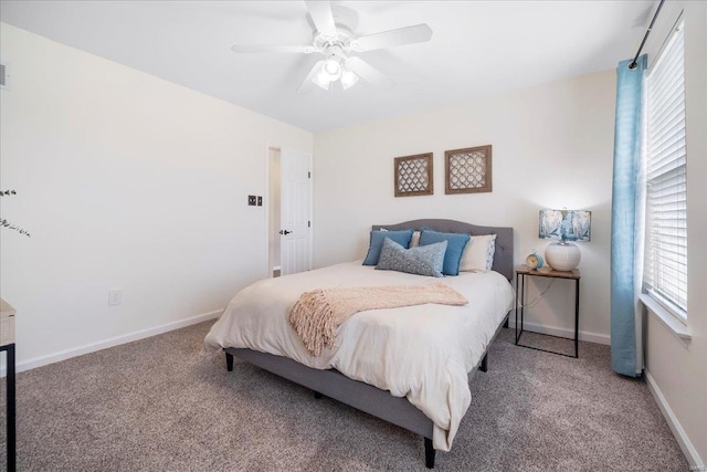 bedroom with carpet, ceiling fan, and multiple windows