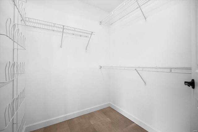 spacious closet with wood finished floors
