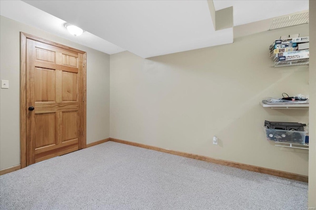 unfurnished room featuring baseboards and carpet flooring