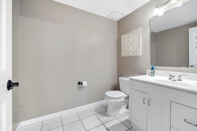 bathroom featuring tile patterned floors, baseboards, toilet, and vanity