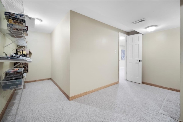 below grade area with visible vents, carpet flooring, and baseboards