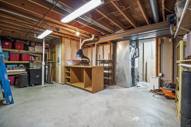 unfinished basement featuring heating unit
