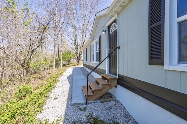 view of side of home with entry steps