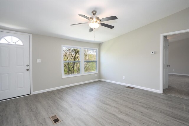 entryway featuring visible vents, baseboards, ceiling fan, and wood finished floors
