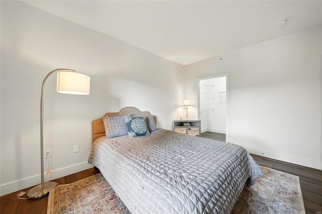 bedroom with baseboards and wood finished floors