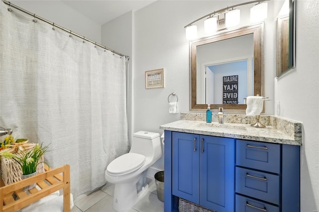 bathroom with vanity, toilet, and tile patterned flooring