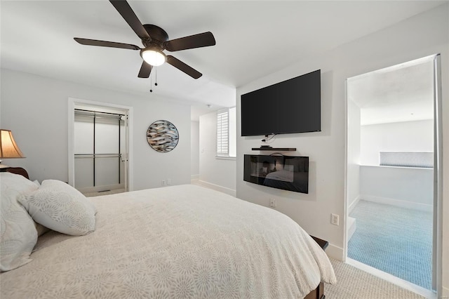carpeted bedroom with ceiling fan and baseboards