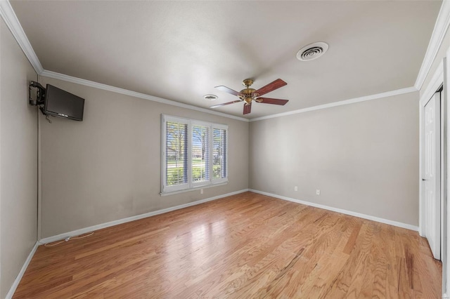 unfurnished bedroom with baseboards, visible vents, ornamental molding, and light wood-style flooring