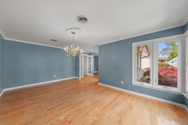 unfurnished room featuring baseboards, a notable chandelier, and crown molding