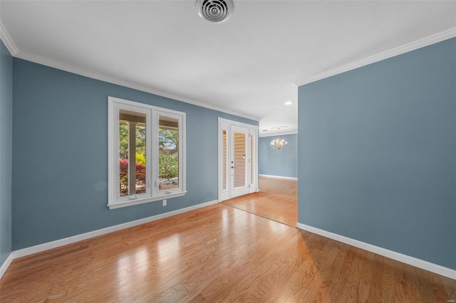 unfurnished room featuring baseboards, ornamental molding, and an inviting chandelier