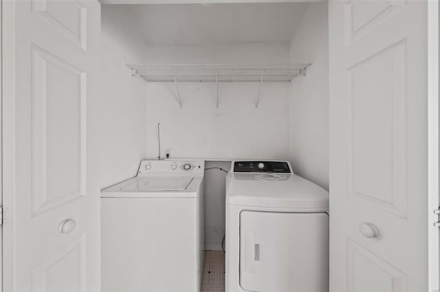 washroom with separate washer and dryer and laundry area
