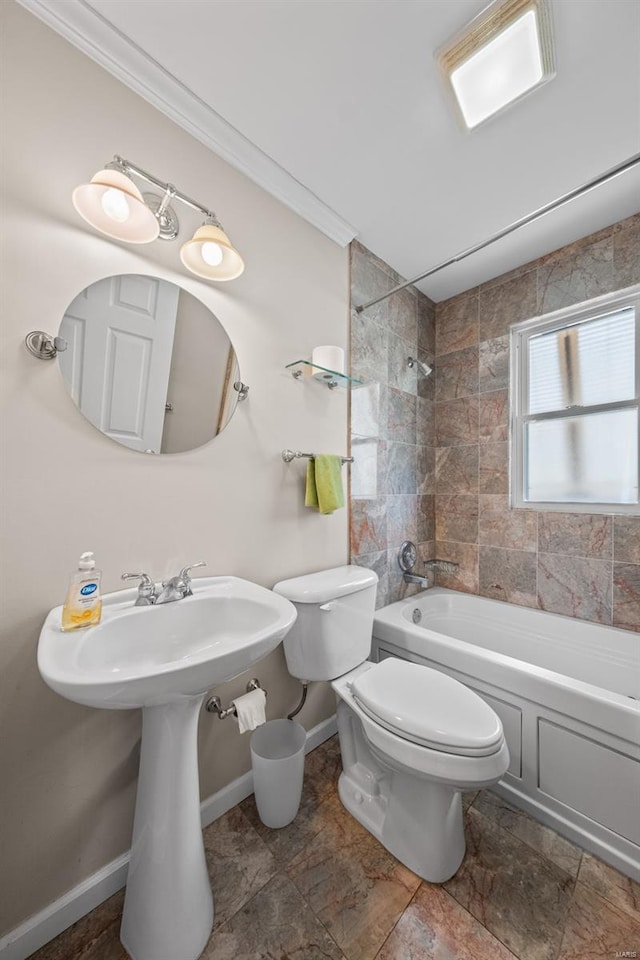 bathroom with toilet, crown molding,  shower combination, and baseboards