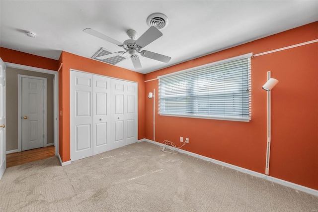 unfurnished bedroom with baseboards, ceiling fan, a closet, and carpet