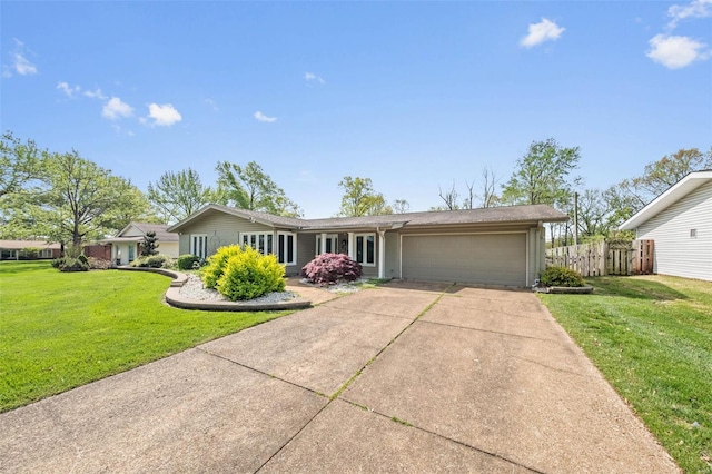 ranch-style home featuring concrete driveway, a garage, a front lawn, and fence