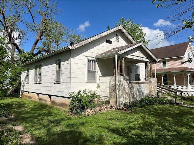 view of front of property with a porch and a front yard