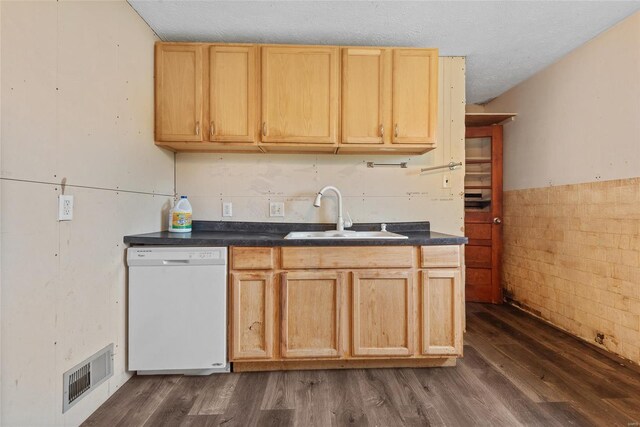 kitchen featuring dishwasher, dark wood finished floors, a sink, and visible vents