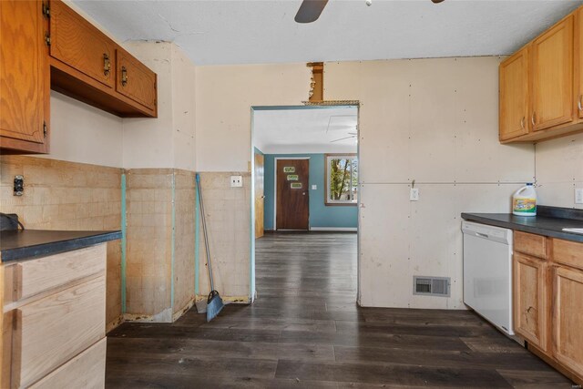 kitchen featuring dark wood finished floors, dark countertops, visible vents, white dishwasher, and ceiling fan