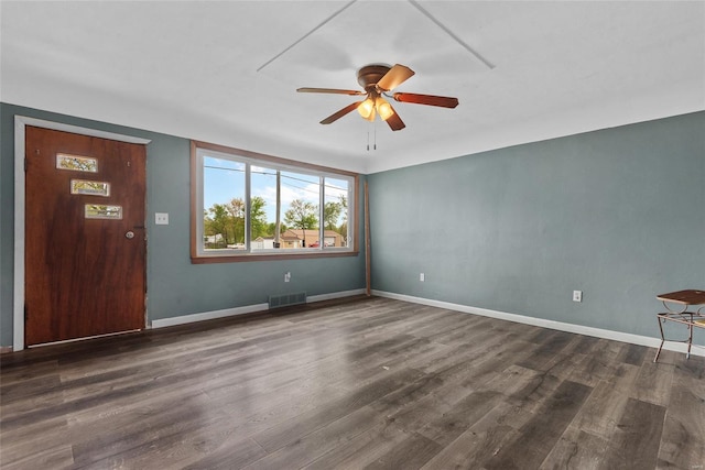 unfurnished room with baseboards, a ceiling fan, wood finished floors, and visible vents