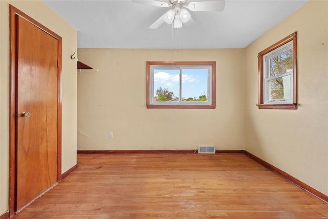 unfurnished bedroom featuring a ceiling fan, a closet, light wood-style flooring, baseboards, and visible vents