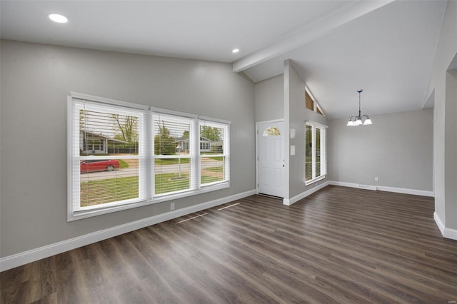 unfurnished living room featuring dark wood finished floors, baseboards, beam ceiling, and a chandelier