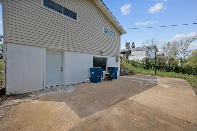view of side of home with a patio area