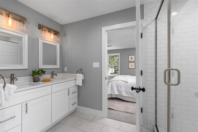 ensuite bathroom featuring a sink, a shower stall, ensuite bath, and marble finish floor
