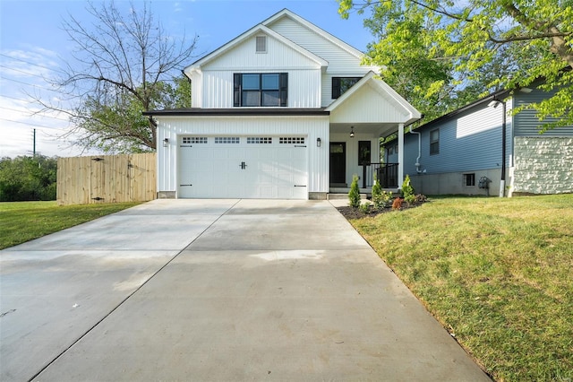 view of front of home featuring a porch, an attached garage, concrete driveway, and a front lawn