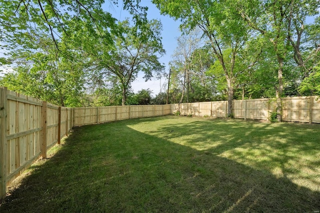 view of yard with a fenced backyard