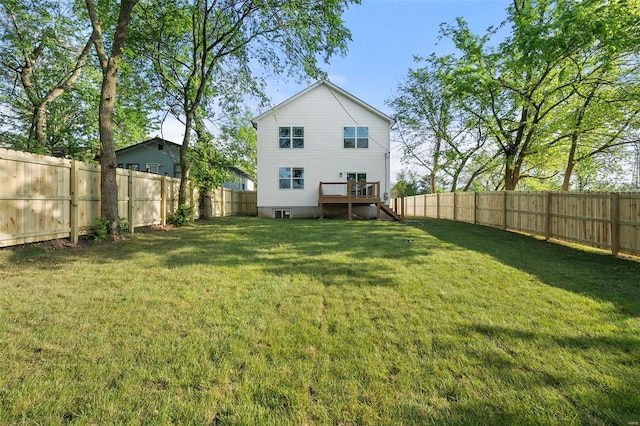 back of house featuring a fenced backyard, a yard, and stairway