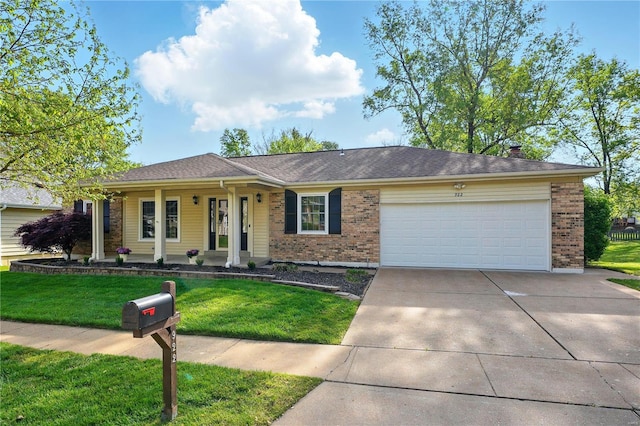 ranch-style home with brick siding, an attached garage, a front lawn, and concrete driveway