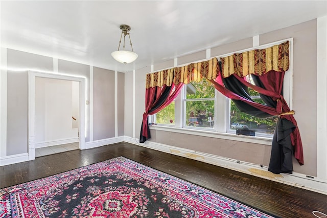 foyer with hardwood / wood-style floors, baseboards, and stairs