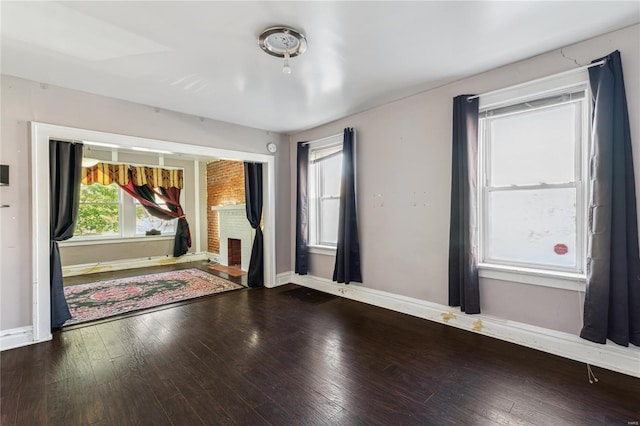 empty room with hardwood / wood-style floors and baseboards