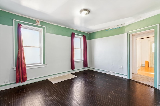 spare room featuring wood-type flooring