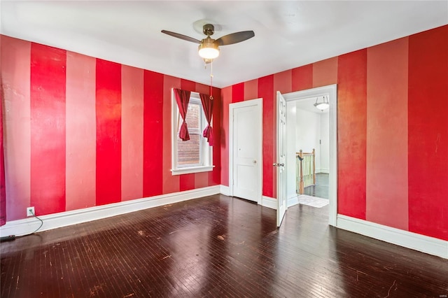 unfurnished room featuring baseboards, wallpapered walls, ceiling fan, and hardwood / wood-style floors