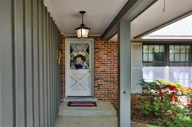 property entrance featuring brick siding