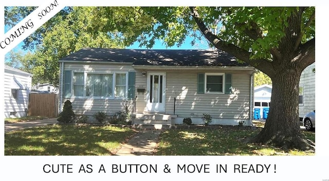 bungalow featuring a front lawn, fence, and entry steps