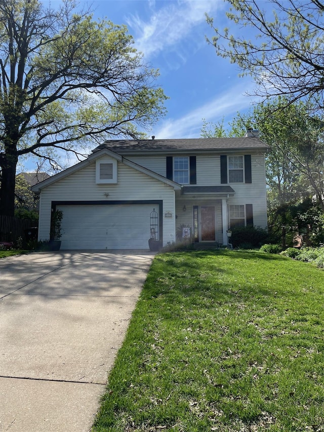 traditional home with an attached garage, a front yard, and concrete driveway