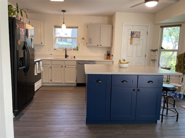 kitchen featuring dishwasher, black refrigerator with ice dispenser, a healthy amount of sunlight, and a sink