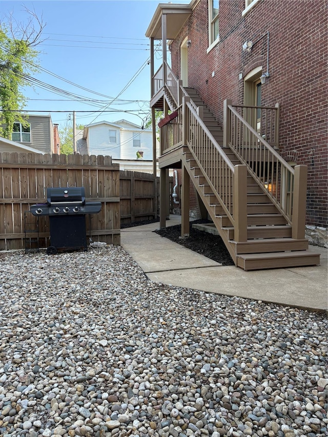 view of patio / terrace with fence, stairway, and area for grilling