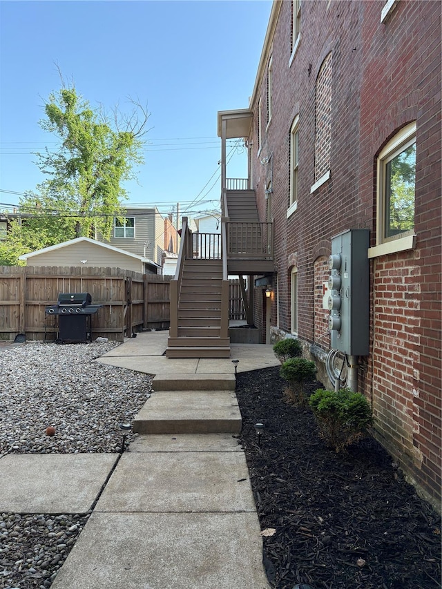 view of yard with stairs and fence