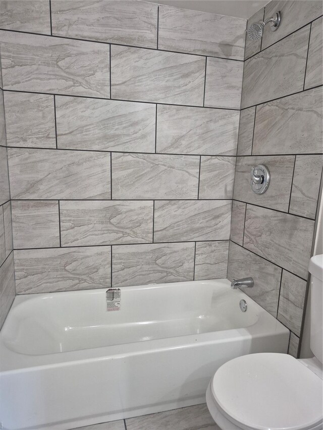 bathroom with toilet and shower / bathtub combination
