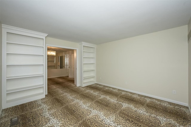 unfurnished room featuring baseboards, carpet, and a chandelier