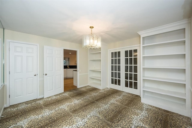unfurnished dining area featuring carpet flooring and a notable chandelier