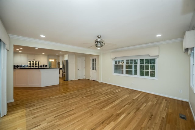 unfurnished living room with ornamental molding, light wood-style floors, baseboards, ceiling fan, and recessed lighting