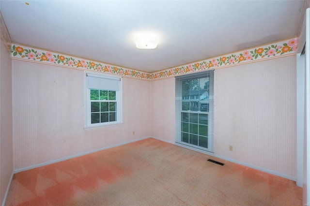 empty room with visible vents, carpet flooring, and baseboards