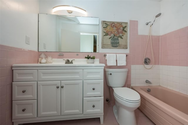 bathroom with tile walls, tile patterned flooring, vanity, and toilet